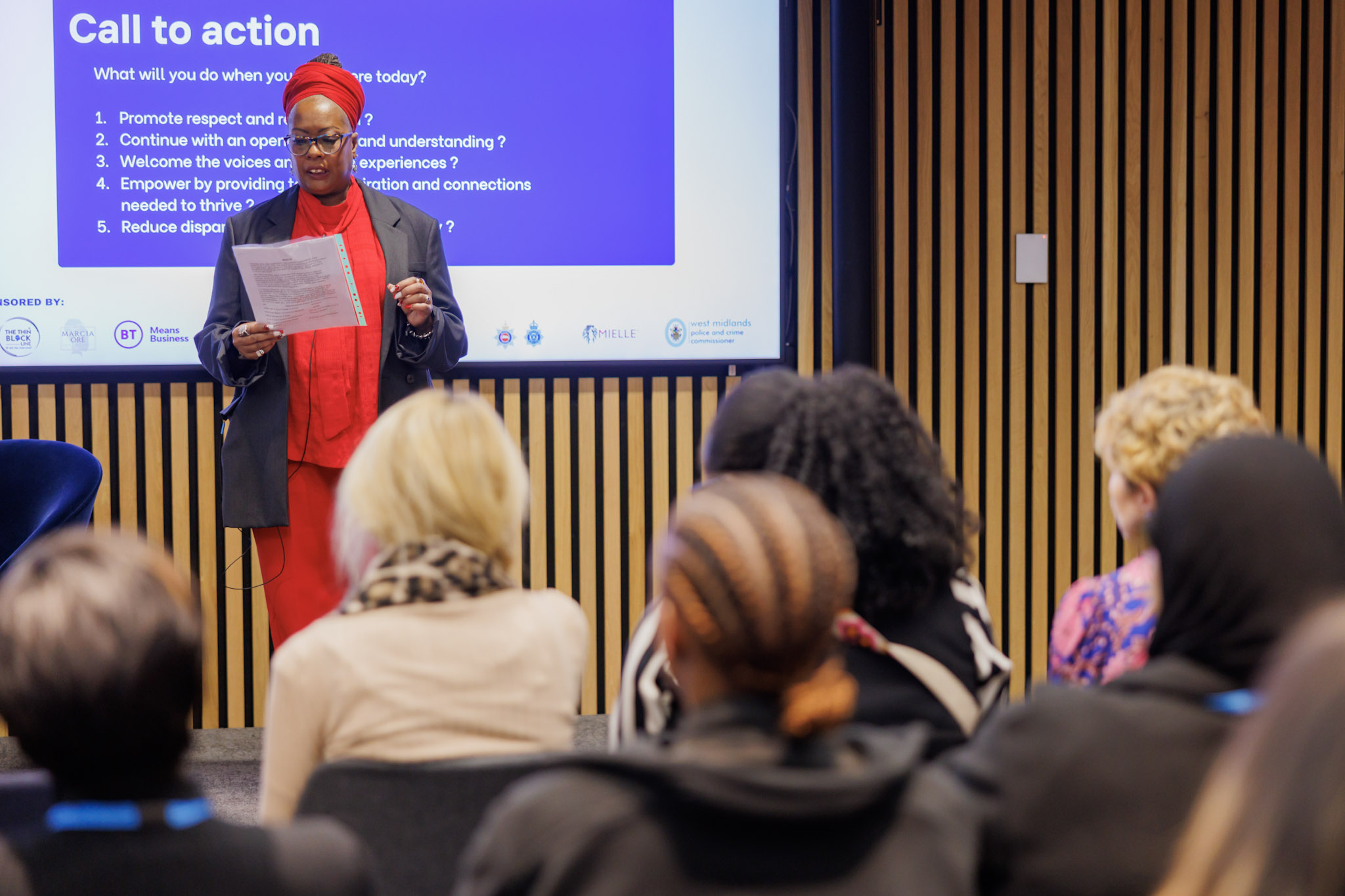 Marcia demonstrating in front of an audience, whilst giving a presentation.